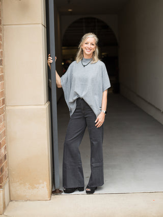 a relaxed fit short sleeve shirt in light gray with a seam down the front great for casual outfits shown with black pants