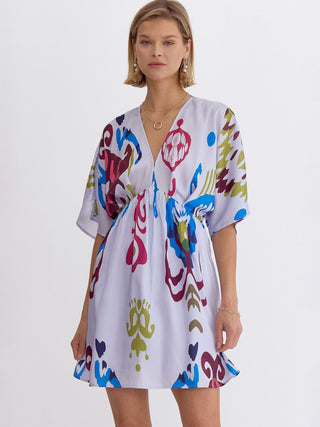 bright and colorful kimono mini dress on lilac grey background with flattering waist design
