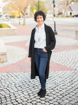 wear this black knee length cardigan with a structured collar and pockets as an everyday winter layer with a white button up
