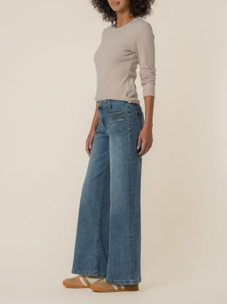high rise wide leg jeans with patch pockets and ruched details worn with a tan top