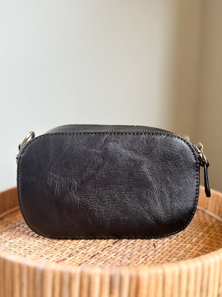 a vegan leather camera bag in black with an accompanying crossbody strap great to gift photography lovers