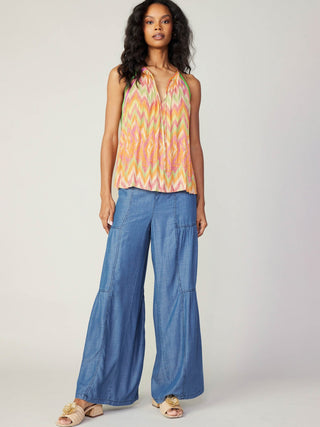 lightweight tropical orange halter top with v neck and self tie closure worn with blue pants