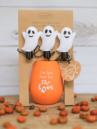 an orange stemless wine glass that reads im just here for the boos with a light up necklace perfect for halloween decor gifts