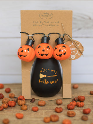 a black stemless wine glass that reads witch way to the wine with a broomstick printed across perfect for halloween decor