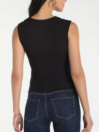 a sleek black tank top with a built in bra and cinched shoulders worn with jeans
