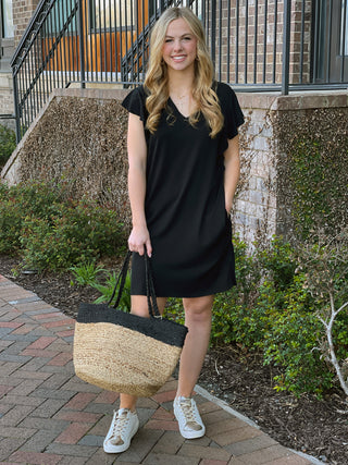 simple black v neck flutter cap sleeved above the knee dress worn with white and gold sneakers
