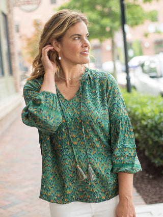 a green print blouse with boho chic tassels in lightweight fabric perfect for summer to fall