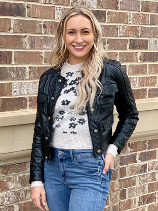 a form fitting cropped black faux leather jacket with quilt detailing and zipper front perfect for everyday layering