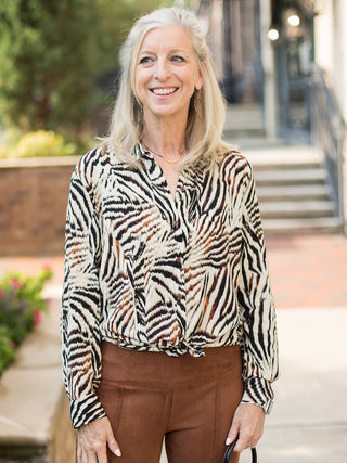 a classy animal print button down blouse with brown and black accents perfect for fall fashion and cold weather layering