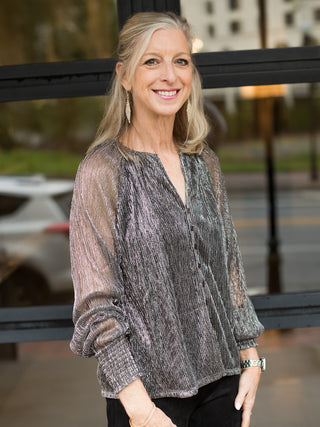 a metallic button down blouse with sheer sleeves with smocked details perfect for a night on the town