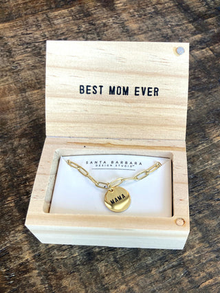 a gold chain link necklace with a round pendant that reads Mama in a wooden jewelry box engraved with best mom ever