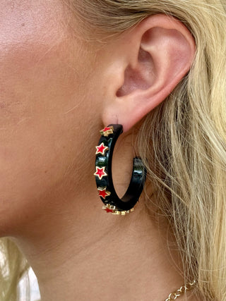 black hoop earring with red and hold stars 