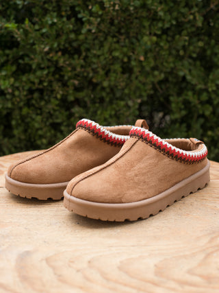 wear this pair of tan slip on winter shoes with red and white stitching for cozy everyday footwear great as a holiday gift