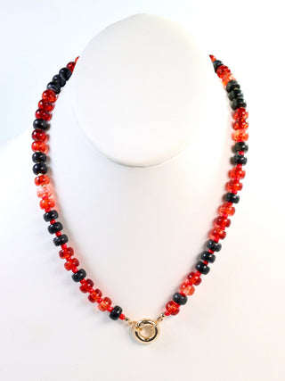 red and black beaded necklace with gold toggle