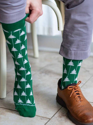 a pair of green and white holiday socks with christmas trees perfect for stocking stuffer gifts