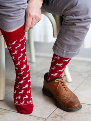 a pair of red and white holiday socks with reindeers perfect for stocking stuffer gifts