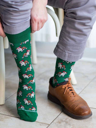 a pair of green and white holiday socks with christmas bulldogs perfect for uga stocking stuffer gifts