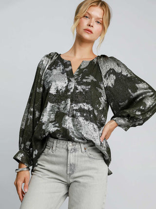 a soft elegant olive metallic v neck blouse with a night time abstract print