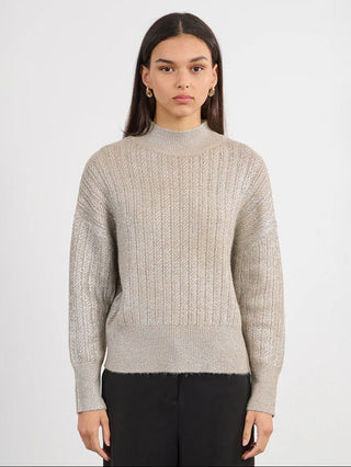 a beige metallic long sleeve knitted sweater with a high ribbed collar