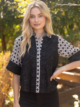 a fun and unique black and white patterned button up blouse