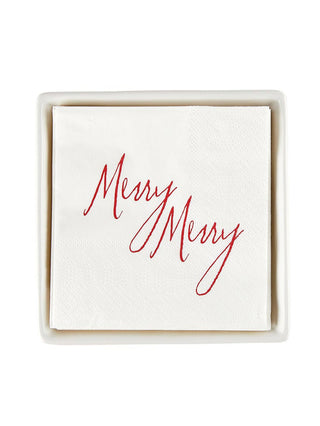 a white ceramic napkin tray with merry christmas napkins