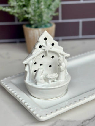 a white ceramic nativity light up sitter