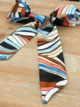 satin like skinny scarf with multi colored  swirl print