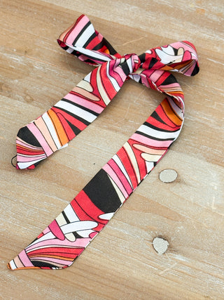 satin like skinny scarf with pink swirl print