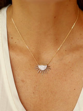 a boho chic mixed metal necklace with a sun symbol for everyday wear and layering