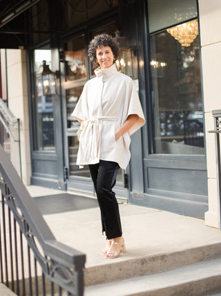 wear this dramatic cream cape poncho with cinched waist for glamorous holiday parties and family photoshoots with black pants