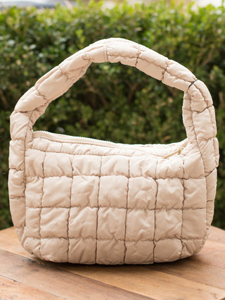 wear this beige quilted handbag as an everyday accessory or gift for the christmas and holiday season