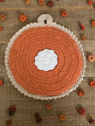 a crochet knit pot holder in the design of pumpkin pie for fall home decor