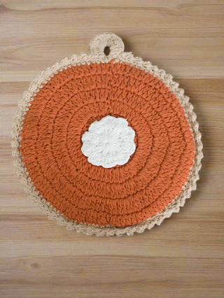 a crochet knit pot holder in the design of pumpkin pie for fall home decor