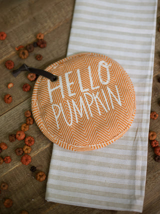 a two piece kitchen set with an orange pot holder that reads hello pumpkin and a striped towel perfect for fall decor gifts