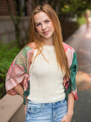 100% silk scarf with flying crane design pink and green florals and corner tassels is shown as a kimono