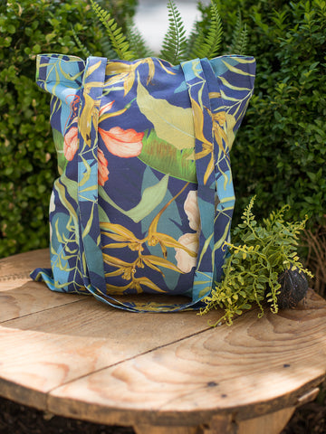 a tropical tote bag in blue and green featuring long shoulder straps