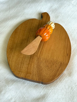 pumpkin shaped pine wood board and matching spreader topped with a hand painted ceramic pumpkin 