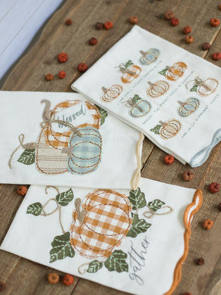 a collection of off white hand towels with embroidered pumpkins with fall sayings perfect for autumn decor