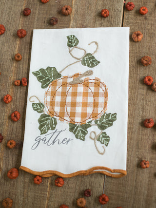 an off white hand towel with embroidered pumpkins that reads gather perfect for fall and thanksgiving decor