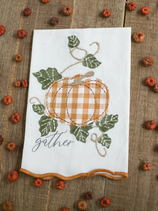an off white hand towel with embroidered pumpkins that reads gather perfect for fall and thanksgiving decor
