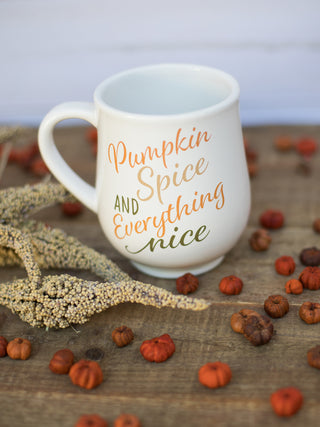 a white mug that reads pumpkin spice and everything nice in orange and green cursive perfect for fall decor gifts