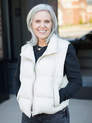 a white puffer vest perfect for layering in fall and winter 