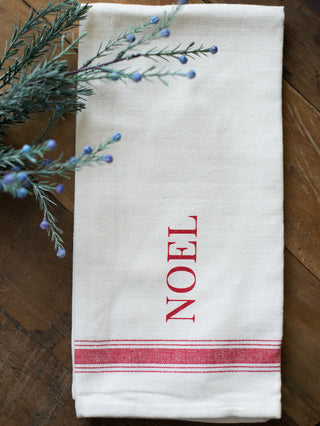 place this white and red tea towel that reads noel in your home as holiday decor or give as a hostess gift