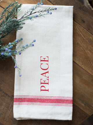 place this white and red tea towel that reads peace in your home as holiday decor or give as a hostess gift