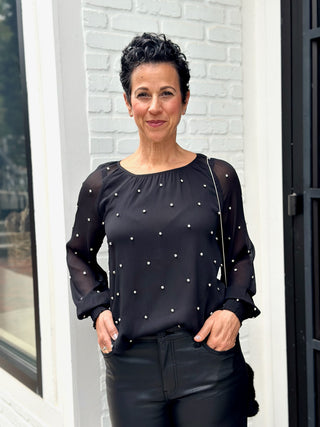 a classy black sheer long sleeve blouse with silver rhinestones and elastic cuffs