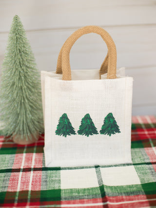 a white holiday present bag with christmas trees perfect for home decor and host gifts