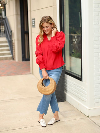 a romantic red top with statement sleeves perfect for summer to fall and valentines day shown with denim pants