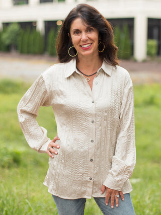 a shiny beige button down blouse in a relaxed silhouette with long sleeves perfect for everyday wear