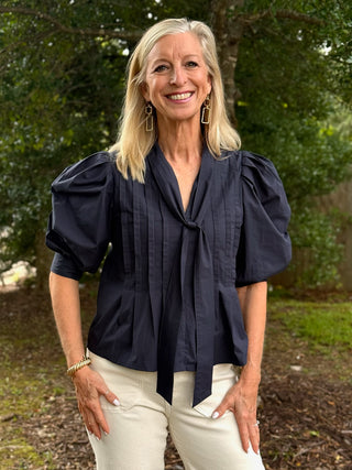 navy blue short puff sleeve blouse with pleats and front tie