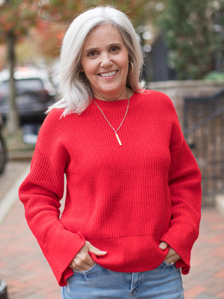 wear this festive ribbed red sweater with statement sleeves and relaxed fit for christmas festivities and holiday parties